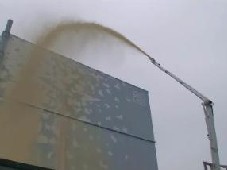 Spraying dust inhibitor over outside walls and roofs of Fukushima Daiichi Nuclear Power Station 