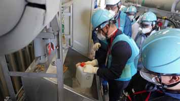 多核種移送設備建屋にて採水している様子（中国の分析機関関係者①）