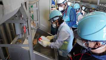 多核種移送設備建屋にて採水している様子（中国の分析機関関係者②）